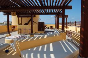 a patio with beds on the roof of a building at El Mosaico Del Sol in Lampedusa