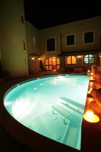 a large swimming pool at night with lights in it at El Mosaico Del Sol in Lampedusa