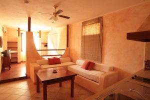 a living room with a couch and a table at El Mosaico Del Sol in Lampedusa