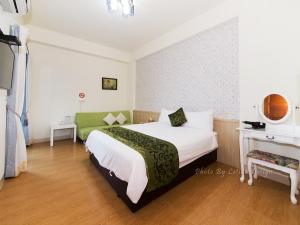 Postel nebo postele na pokoji v ubytování Four Seasons Homestay