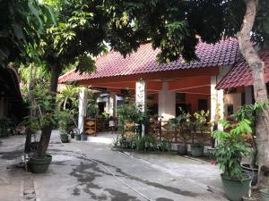 a building with trees and plants in front of it at Hotel Seno in Yogyakarta
