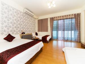 Postel nebo postele na pokoji v ubytování Four Seasons Homestay