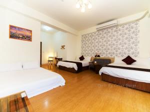 Postel nebo postele na pokoji v ubytování Four Seasons Homestay