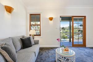 a living room filled with furniture and a window at Bellevue Accommodation in Kiama