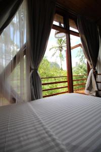 Voodi või voodid majutusasutuse Padi Ecolodge toas
