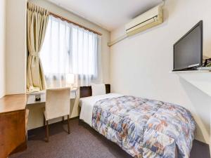 Кровать или кровати в номере Hotel Crane Tachibana