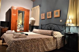 a bedroom with a bed with a dresser and a mirror at Villas Panorama Apolpaina Lefkas in Apolpaina