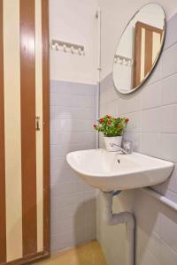 a bathroom with a sink and a mirror at Home Art 103 in Ipoh