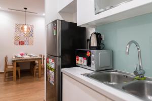 a kitchen with a stainless steel refrigerator and a sink at Park Hill No1 Apartment in Hanoi +20 photos