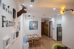 a living room with a table and a kitchen at Park Hill No1 Apartment in Hanoi