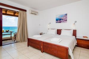 a bedroom with a bed with a view of the ocean at Ammos Residence in Minia