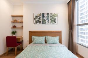 a bedroom with a bed and a desk and a window at Park Hill No1 Apartment in Hanoi