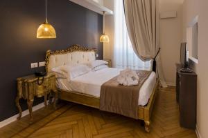 a bedroom with a bed and a table and a television at Mediterraneo Emotional Hotel & Spa in Santa Margherita Ligure