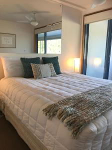 a large white bed in a room with a window at Perano on the Quay in Picton