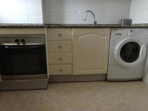 a kitchen with a washing machine and a dishwasher at Faraon Park in La Pineda