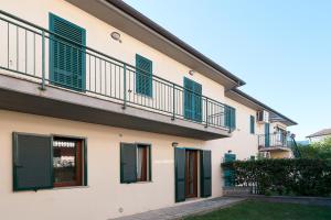 a building with green shutters and a balcony at Salice in Marina di Campo