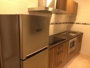 Kuchyň nebo kuchyňský kout v ubytování Apartamentos Augusto