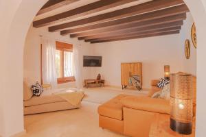 a living room with a couch and a table at Villa Mirador, Javea in Balcon del Mar