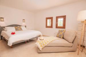 a bedroom with a bed and a couch at Villa Mirador, Javea in Balcon del Mar +32 photos