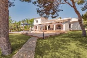 an exterior view of a house with a yard at Villa Mirador, Javea in Balcon del Mar