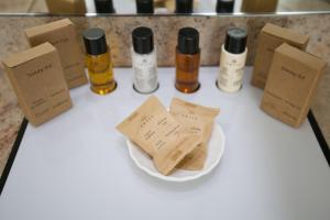 a table with bottles of essential oils and a plate at Golden Bay Beach Hotel in Larnaca