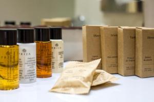 a group of four bottles of essential oils next to boxes at Golden Bay Beach Hotel in Larnaca