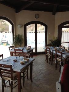 una sala da pranzo con tavoli e sedie in legno di il casale san martino a Norcia