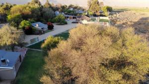 an aerial view of a house with trees and a driveway at Tarantula Guest House in Calvinia