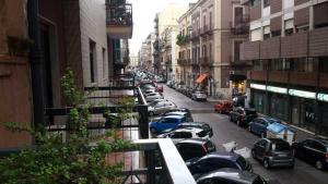 a city street filled with parked cars and buildings at House of Arts in Bari