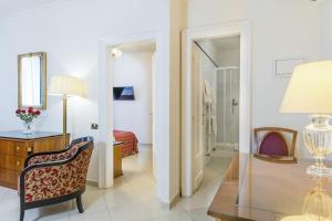 a room with a desk and a chair and a mirror at Hotel Bologna in Prague