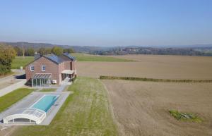an aerial view of a house with a swimming pool and a field at Vue d'en Haut in Durbuy
