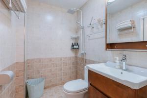 a bathroom with a sink and a toilet and a mirror at Xi'an Yanta·High-tech CBD· Locals Apartment 00171700 in Xi'an +30 photos