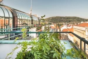 a view of a city from a balcony with a plant at Residence Bologna in Prague
