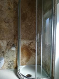 a shower with a glass door in a bathroom at La Casetta in Tellaro