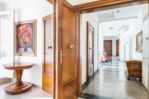 a hallway with a wooden door and a table at Hotel Bologna in Prague