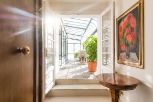 a hallway with a wooden door and a table at Hotel Bologna in Prague