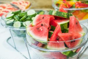 a group of three bowls filled with watermelon and vegetables at Hotel Bologna in Prague