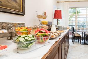 a buffet with bowls of food on a counter at Hotel Bologna in Prague