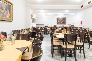 a dining room filled with tables and chairs at Hotel Bologna in Prague