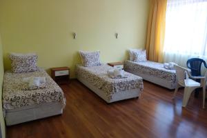 a living room with two beds and a couch at Aquamarine in Sozopol