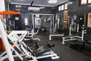 a gym with several tread machines in a room at Aquamarine in Sozopol