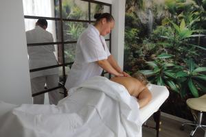 a man getting a massage from a man in a chair at Aquamarine in Sozopol