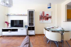 a living room with a dining table and a tv at piso san isidro in San Isidro