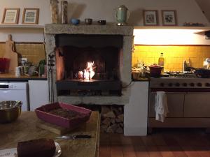 a kitchen with a oven with a fire in it at Les Aiguières en Provence in Suze-la-Rousse