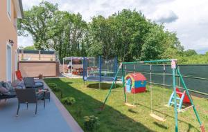 a backyard with a play yard with a playground at Villa Dina in Nedeščina