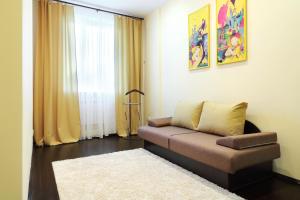 a living room with a couch and a rug at PaulMarie Apartments on Lenina Avenue in Gomel