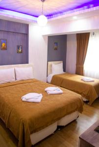 Postel nebo postele na pokoji v ubytování Figen Hotel