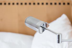 a microphone on top of a bed at Art Déco Hotel Elite in Biel