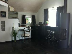 a kitchen with a table and chairs in a room at Lodge & lake in Buchillon