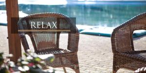 two wicker chairs with the word relax written on them at Parc Hotel in Poppi